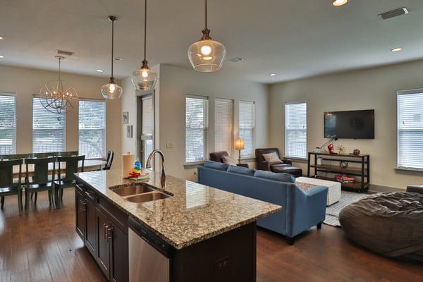 Paradise on Penelope open-plan kitchen and living area with granite island and pendant lights, Miramar Beach FL